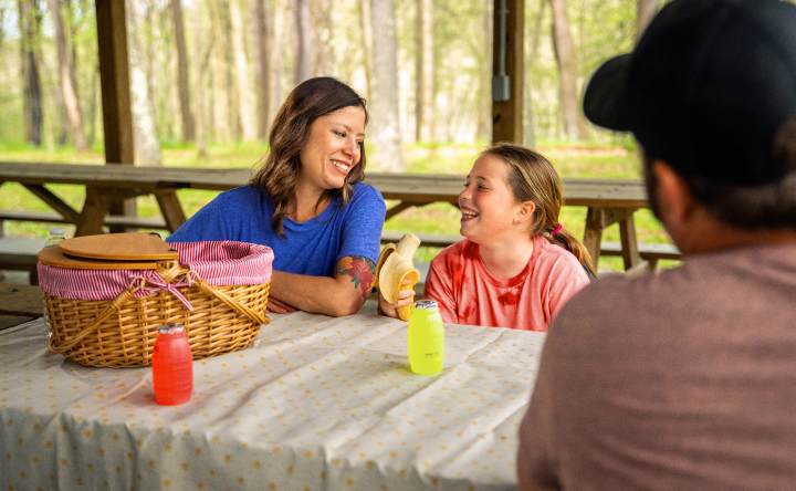 Katie, a TZIELD® (teplizumab-mzwv) patient, having a picnic with her family outdoors